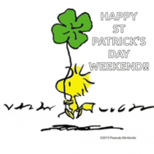a cartoon of woodstock holding a four leaf clover .