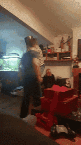 a man carrying a child in a living room