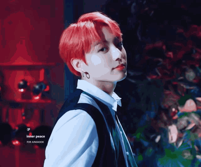 a young man with red hair is wearing a white shirt