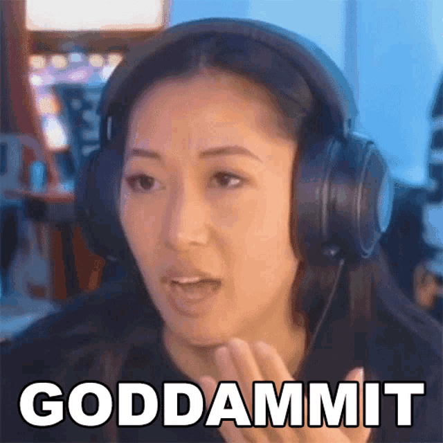 a woman wearing headphones is making a funny face and says goddammit