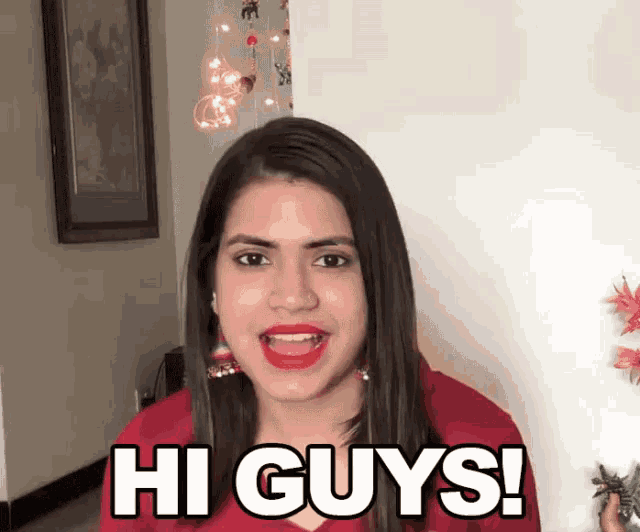 a woman says hi guys in a red shirt