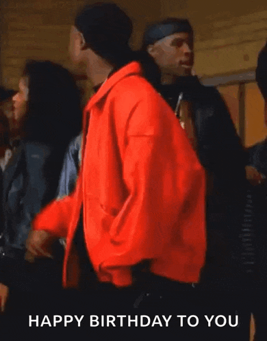 a man in a red jacket says " happy birthday to you " while smoking a cigarette