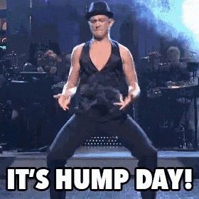 a man is dancing on stage with the words it 's hump day