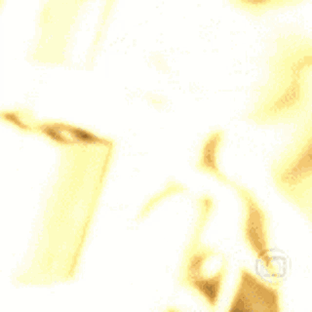a blurry picture of a person talking on a phone with a yellow background