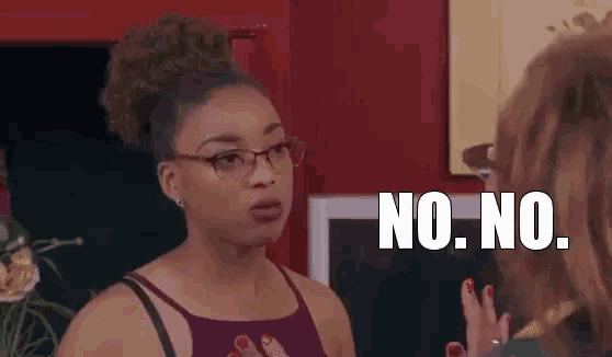a woman wearing glasses is talking to another woman and says no .