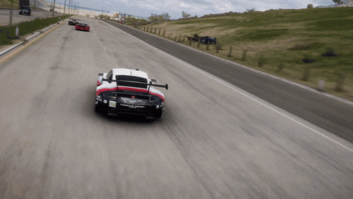 a porsche race car is driving down a track