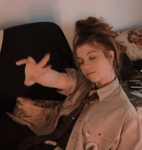 a woman sitting on a couch with her eyes closed