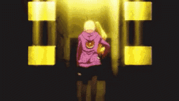 a person wearing a purple hoodie with a smiley face on the back