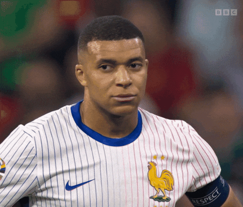 a man wearing a jersey with a rooster on it and a bbc logo