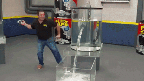 a man dancing in front of a flex tape display
