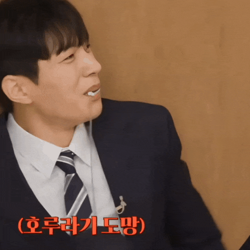 a man in a suit and tie with korean writing on the bottom of his face