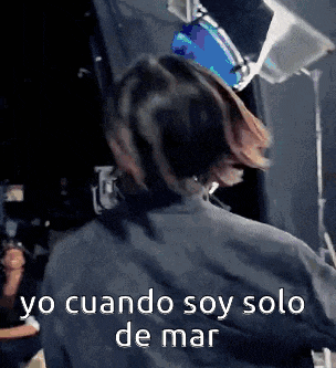 a woman in a black shirt is standing in front of a drum set and says yo cuando soy solo de mar