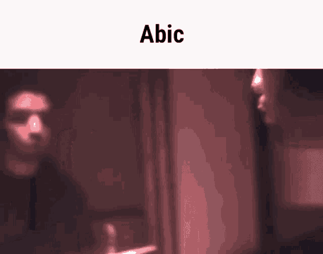 a blurry picture of a man and a woman with the word abic on the bottom