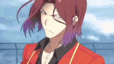 a man with red hair and purple streaks is wearing a red jacket and black shirt