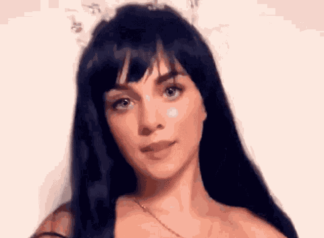 a woman with long black hair is wearing a wig and a cat ear headband .