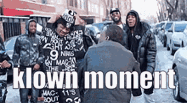 a group of men are standing on a street with the words " klown moment " written on the bottom