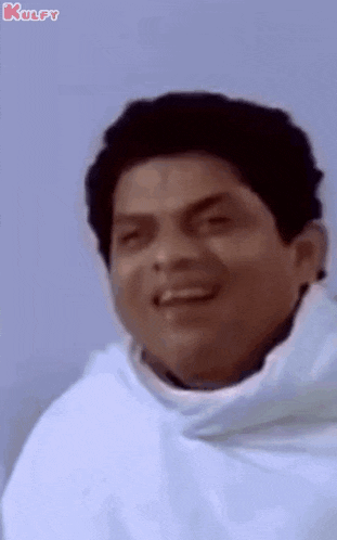 a close up of a man wearing a white hoodie and smiling .