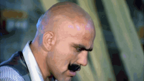 a bald man with a mustache is wearing a white shirt