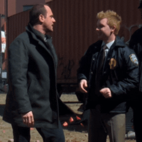 two men are standing next to each other and one has a patch on his jacket that says ' u.s. army '