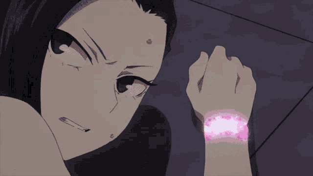 a close up of a person 's wrist with a pink bracelet on it