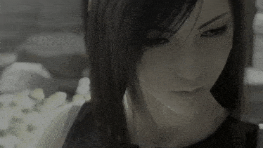 a close up of a woman 's face with long black hair