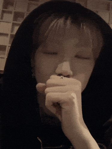 a close up of a person 's face with a hoodie on
