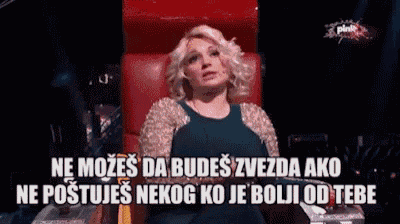 a woman in a blue dress is sitting in a red chair with a caption in a foreign language