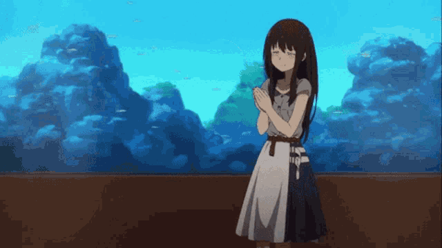 a girl standing in front of an aquarium with a blue sky in the background