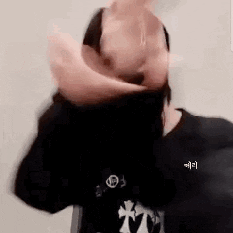 a person is covering their face with their hands and making a funny face .