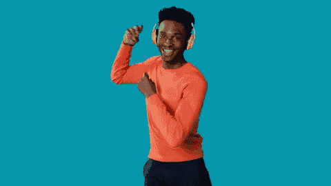 a man wearing headphones is dancing and smiling