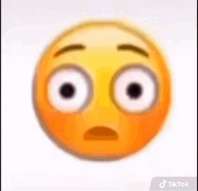 a close up of a smiley face with big eyes and a surprised expression .