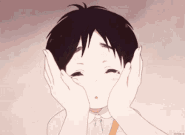 a young boy is covering his face with his hands and making a face .