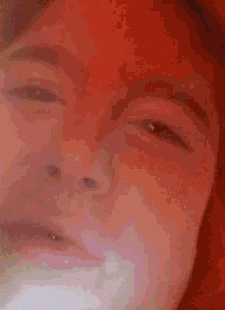 a close up of a person 's face with their eyes closed