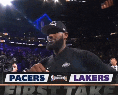 a man stands in front of a pacers and lakers first take sign