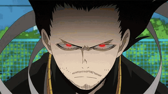 a man with red eyes and a beard is looking at the camera