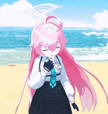 a girl with pink hair and a tie is standing on a beach near the ocean .