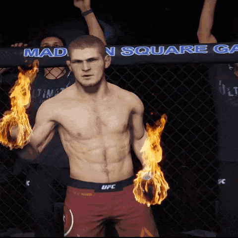 a man in a ufc shorts with flames in his hands