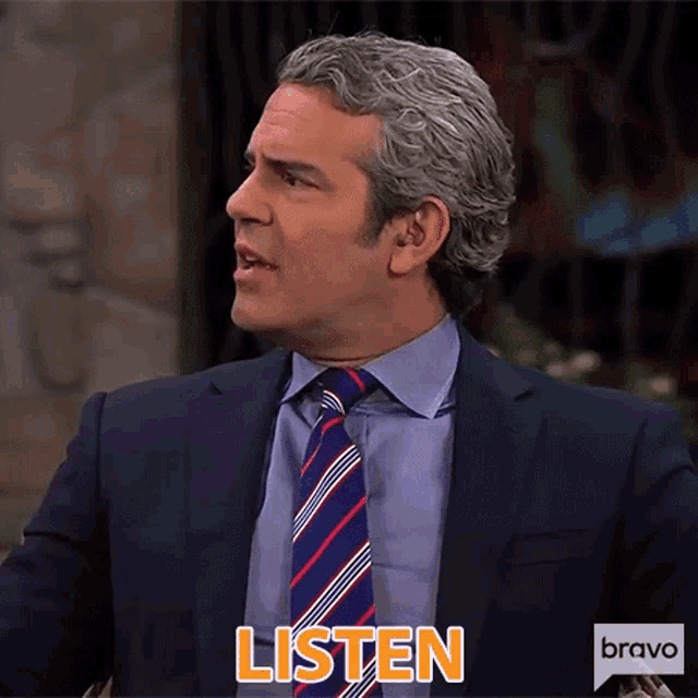 a man in a suit and tie is saying listen .