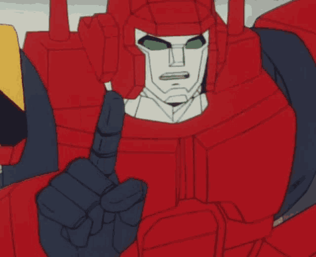 a red robot with green eyes is pointing up