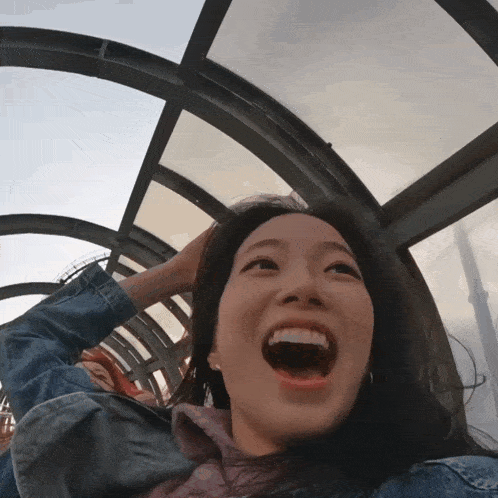 a woman with her mouth wide open looks up at the sky