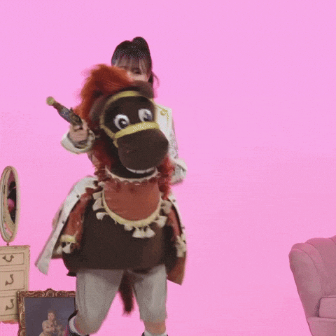a woman is riding a stuffed horse with a gun in her hand