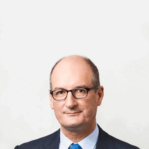 a man in a suit and tie has a very tall head
