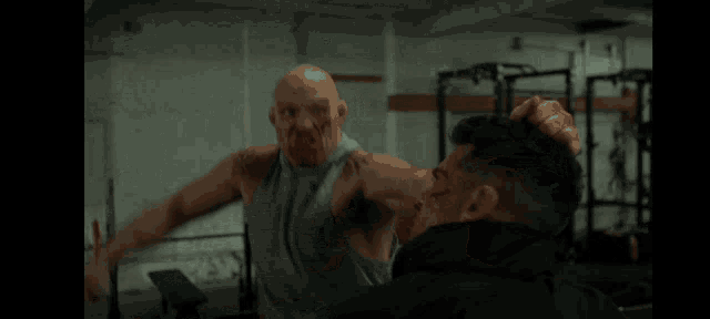 a man with a tattoo on his arm is being punched by another man