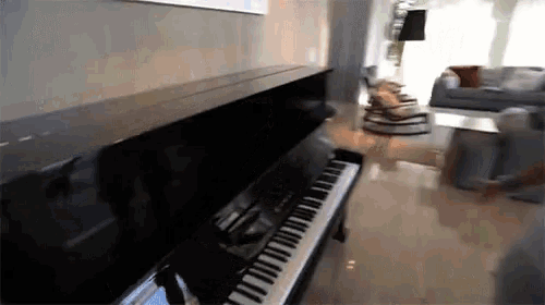 a piano is in a living room with a couch and chairs