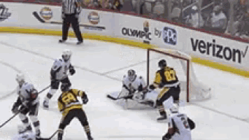 a hockey game is being played on a rink with a verizon advertisement
