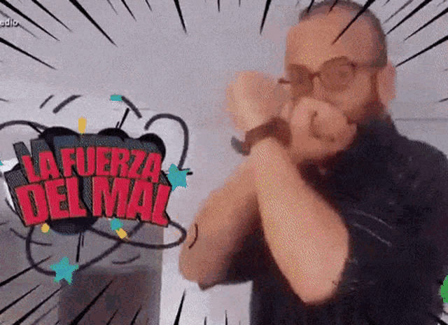 a man is holding a microphone in front of a sign that reads la fuerza del mal