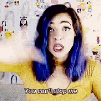 a woman with blue hair is making a funny face and says you can 't stop me