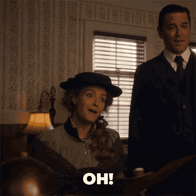 a man and a woman are standing next to each other and the woman is saying oh