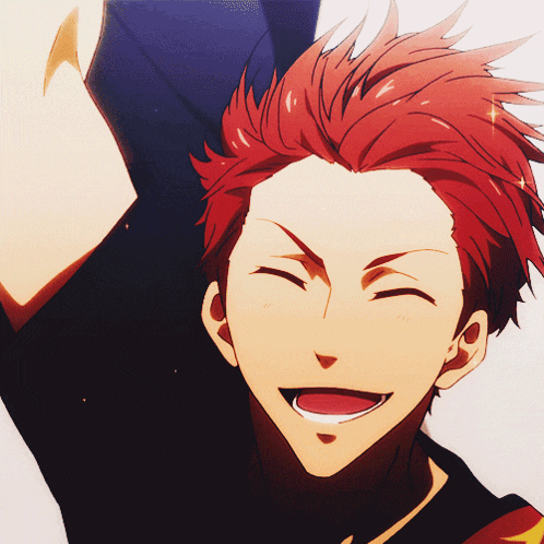a man with red hair and a black shirt smiles with his eyes closed