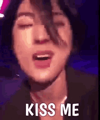 a close up of a person 's face with their eyes closed and the words `` kiss me '' written on it .
